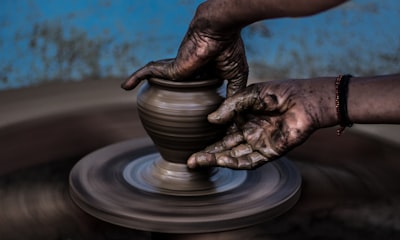 Hands shaping clay